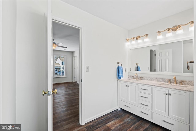 bathroom featuring ceiling fan, vanity, and wood-type flooring