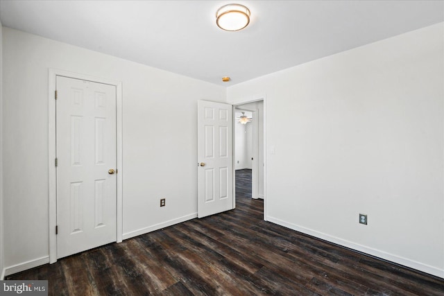 unfurnished bedroom with dark hardwood / wood-style flooring