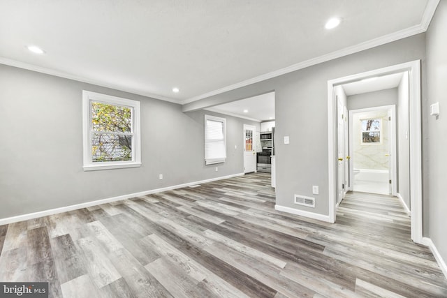 unfurnished living room with light hardwood / wood-style floors and ornamental molding