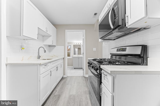 kitchen featuring sink, white cabinets, and stainless steel appliances