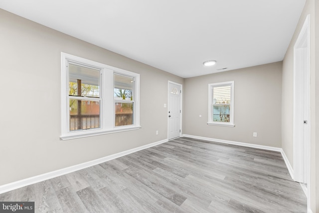 empty room with light hardwood / wood-style flooring