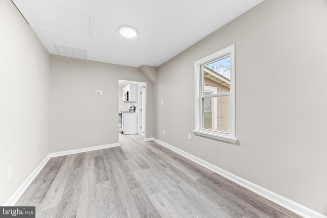 spare room featuring light hardwood / wood-style floors