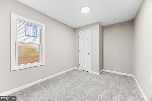 unfurnished bedroom featuring light carpet