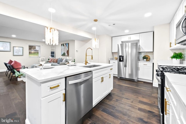 kitchen with white cabinets, appliances with stainless steel finishes, dark hardwood / wood-style floors, and sink