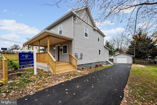 view of front of home with a porch, a garage, and an outdoor structure