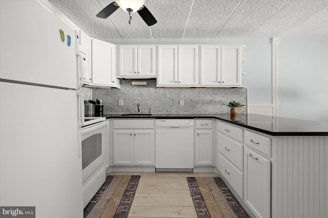 kitchen featuring white cabinetry, sink, and white appliances