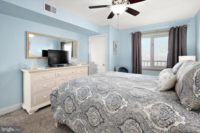 bedroom with carpet flooring, ceiling fan, and a textured ceiling