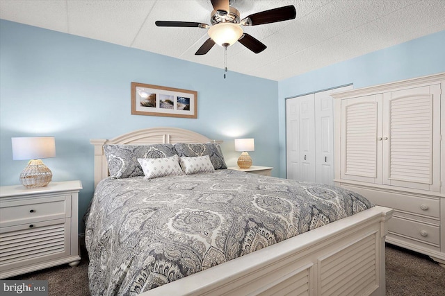 carpeted bedroom with ceiling fan and a closet