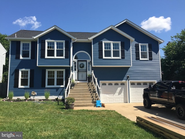 view of front of house with a front yard and a garage