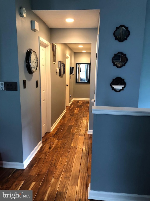 corridor with dark hardwood / wood-style floors