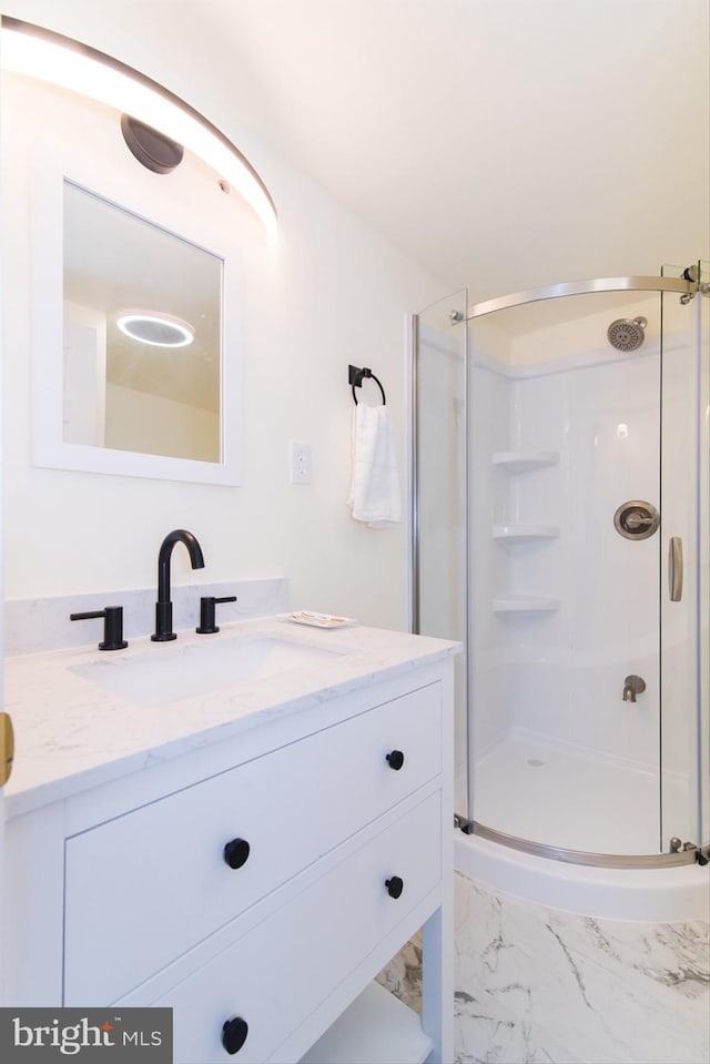 bathroom with vanity and a shower with door