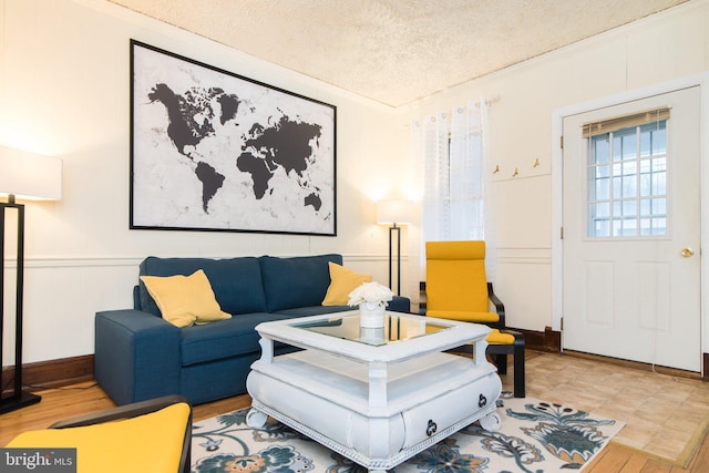 living room with a textured ceiling and ornamental molding