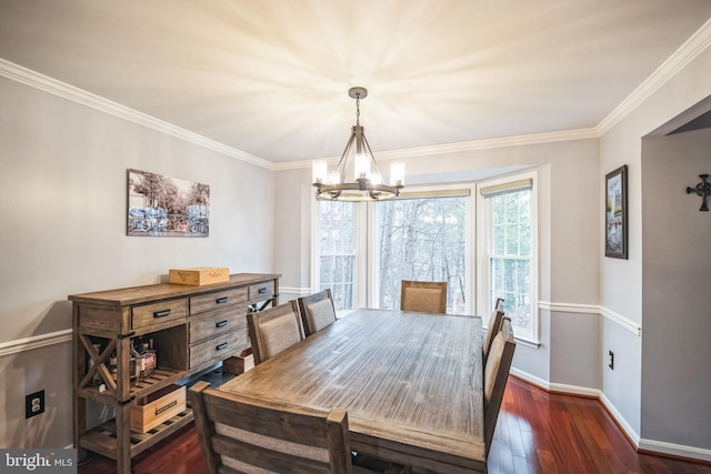 dining area with crown molding, dark wood-type flooring, and a chandelier