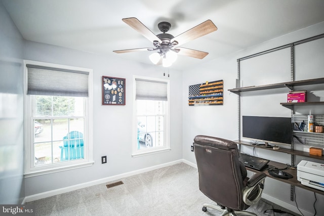 home office featuring light colored carpet and ceiling fan