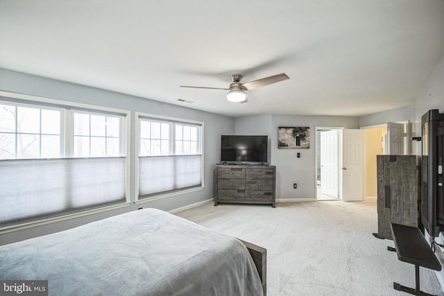 bedroom featuring light colored carpet and ceiling fan