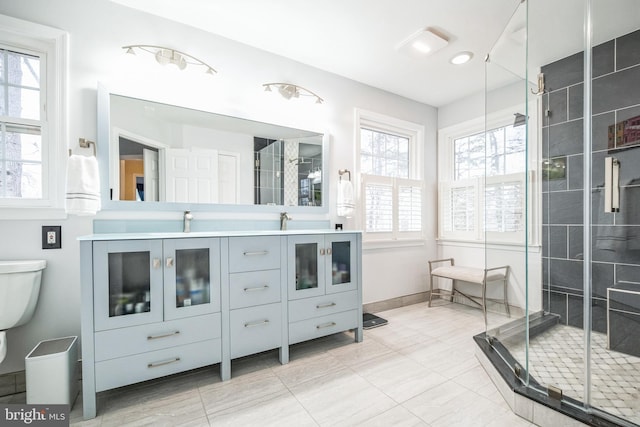 bathroom with vanity, toilet, and walk in shower