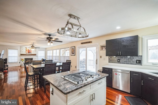 kitchen featuring white cabinetry, a wealth of natural light, dark hardwood / wood-style flooring, and appliances with stainless steel finishes