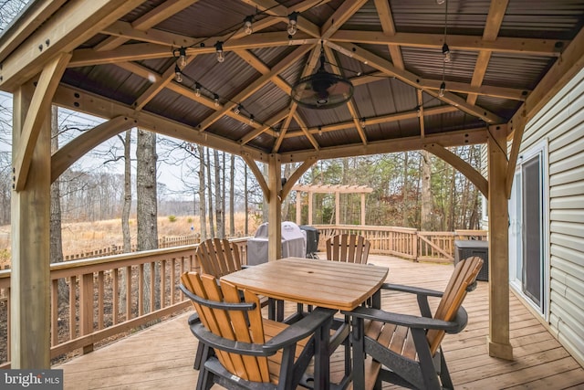 wooden deck featuring a gazebo and cooling unit