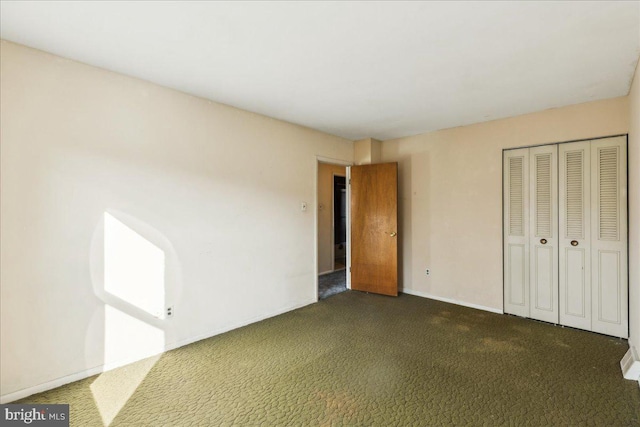 unfurnished bedroom featuring dark colored carpet and a closet