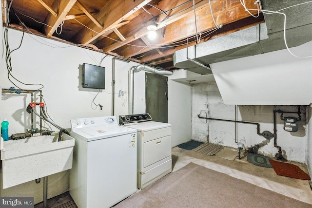 clothes washing area with independent washer and dryer and sink