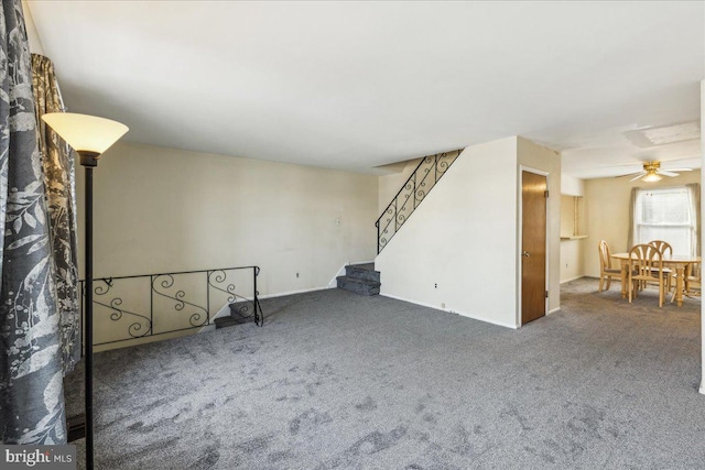 spare room featuring ceiling fan and carpet