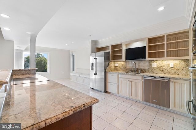 kitchen featuring tasteful backsplash, stainless steel appliances, crown molding, sink, and light tile patterned floors