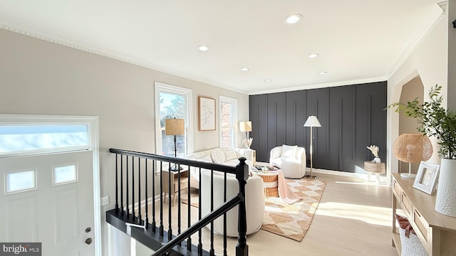 interior space featuring light wood-type flooring and crown molding