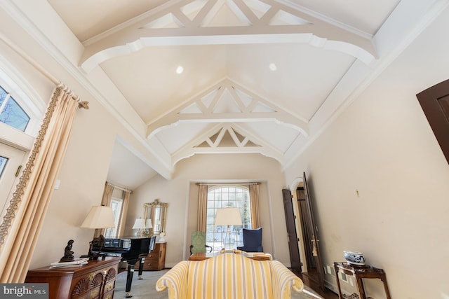 bedroom with crown molding and high vaulted ceiling