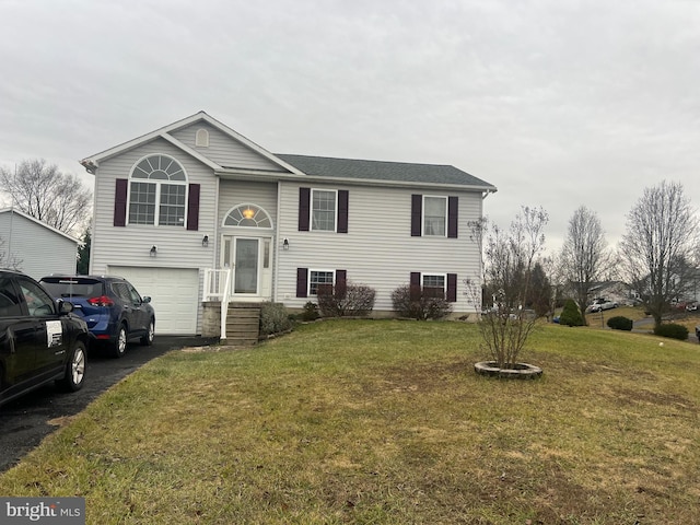 bi-level home with a front lawn and a garage