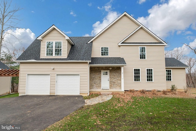 view of property featuring a garage and a front yard