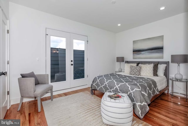 bedroom featuring hardwood / wood-style floors, access to exterior, and french doors