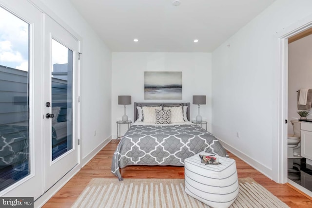 bedroom featuring light hardwood / wood-style floors and connected bathroom