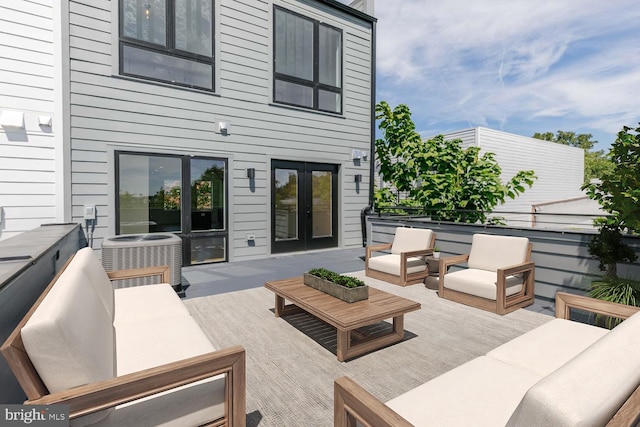 wooden deck featuring central AC, outdoor lounge area, and french doors