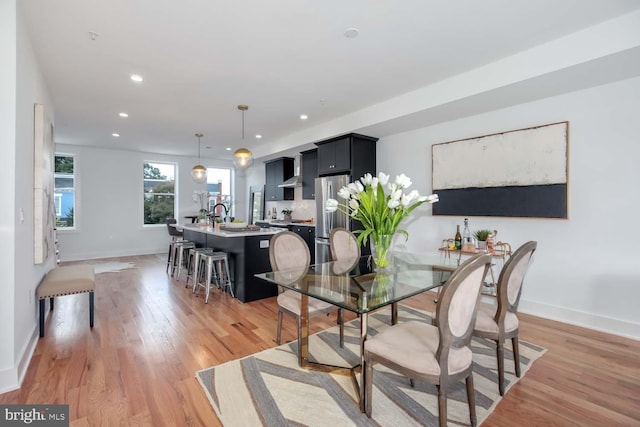 dining room with light wood-type flooring and sink