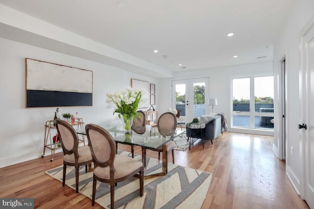 dining area featuring french doors and light hardwood / wood-style flooring