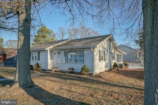 ranch-style house with cooling unit and a front yard