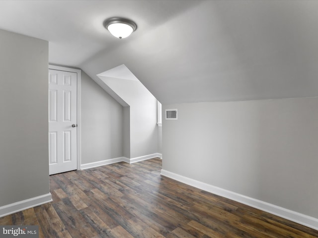 bonus room featuring dark hardwood / wood-style flooring and lofted ceiling