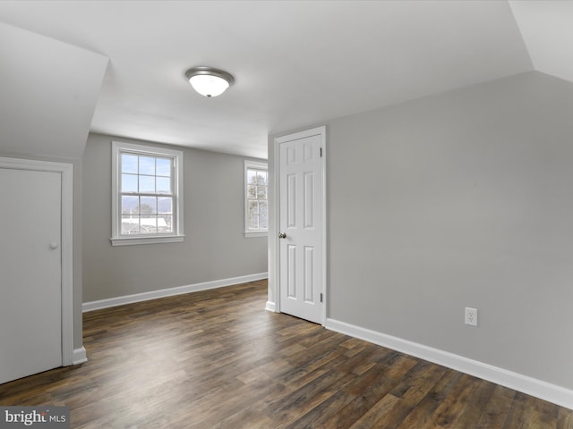 bonus room featuring dark wood-type flooring and lofted ceiling