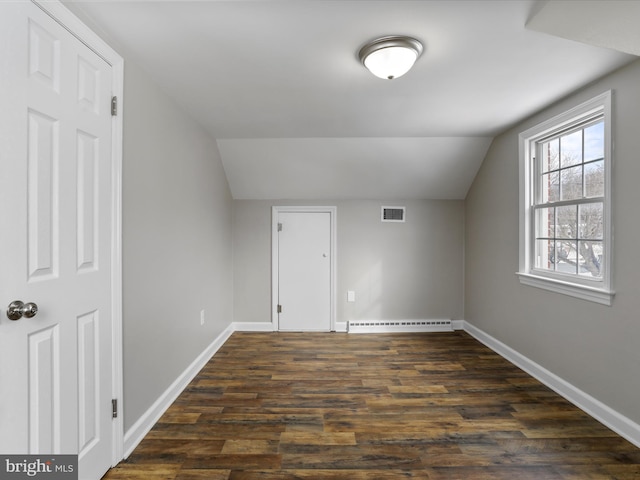 bonus room with lofted ceiling, dark hardwood / wood-style floors, and a baseboard heating unit