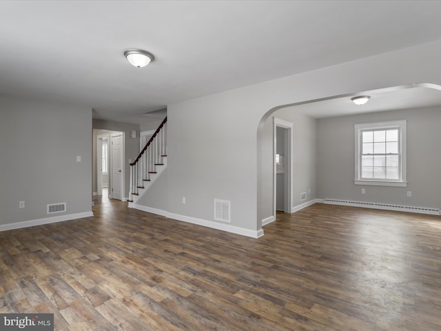 unfurnished room featuring a baseboard radiator and dark hardwood / wood-style flooring