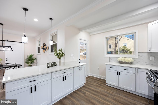 kitchen with pendant lighting, light stone countertops, white cabinetry, and high end stainless steel range oven