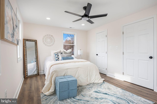 bedroom with ceiling fan and dark wood-type flooring