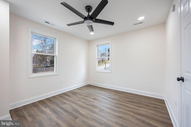 spare room with dark hardwood / wood-style floors and ceiling fan