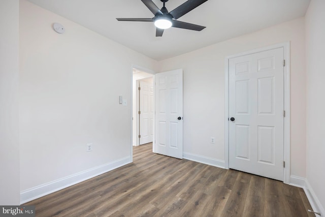 unfurnished bedroom with dark hardwood / wood-style floors and ceiling fan