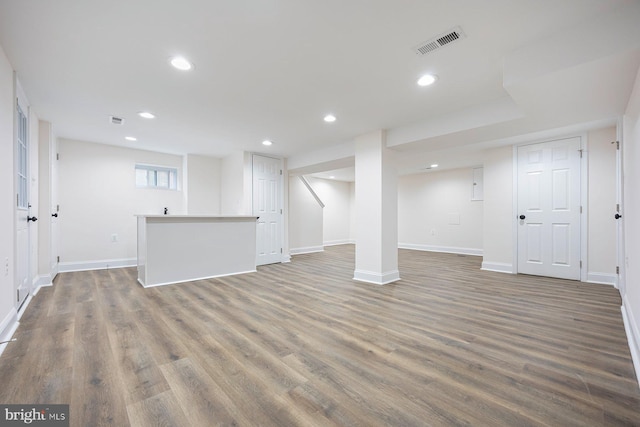 basement featuring dark hardwood / wood-style flooring