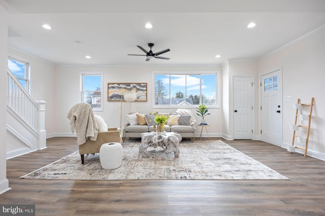 living room featuring ceiling fan, dark hardwood / wood-style flooring, and a wealth of natural light