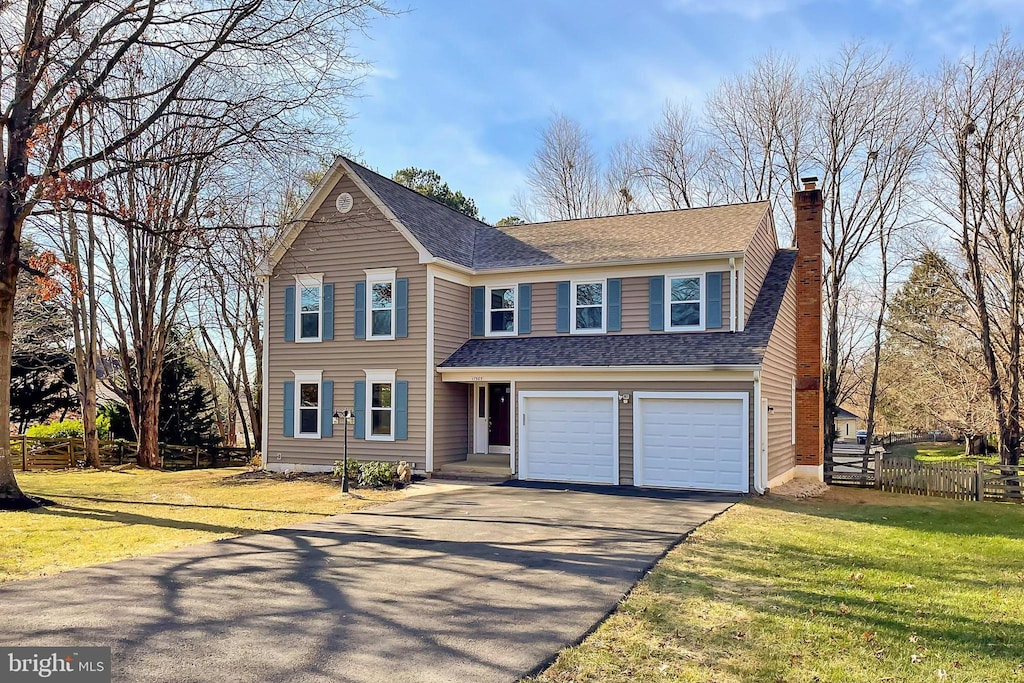 view of front of house with a front yard and a garage