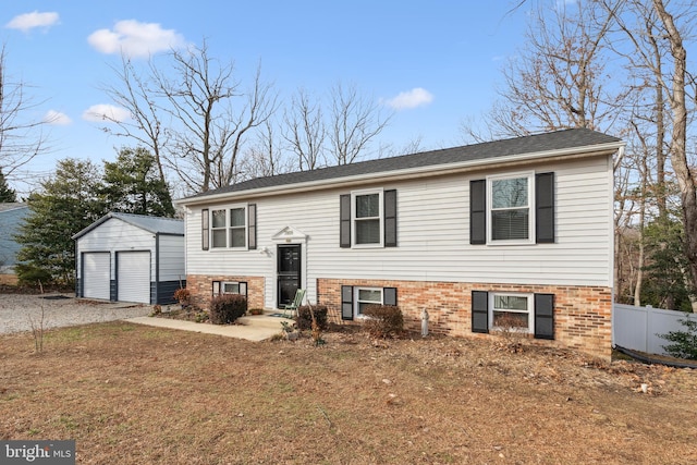 bi-level home with a garage and an outdoor structure