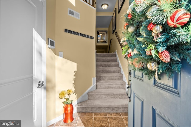 stairs with tile patterned floors