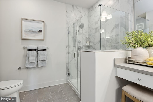 bathroom featuring tile patterned floors, toilet, and a shower with door